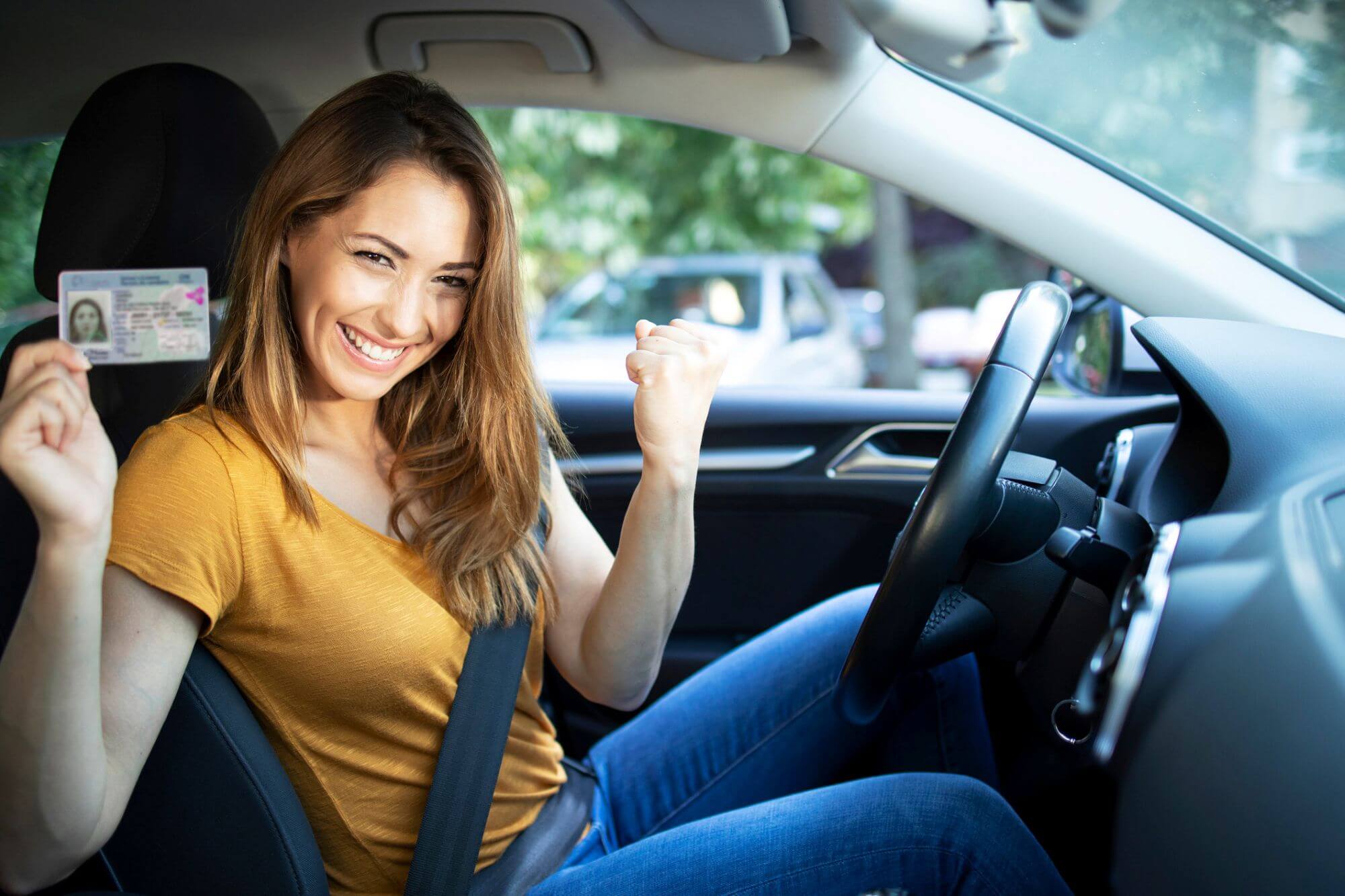 Happy woman with drivers license